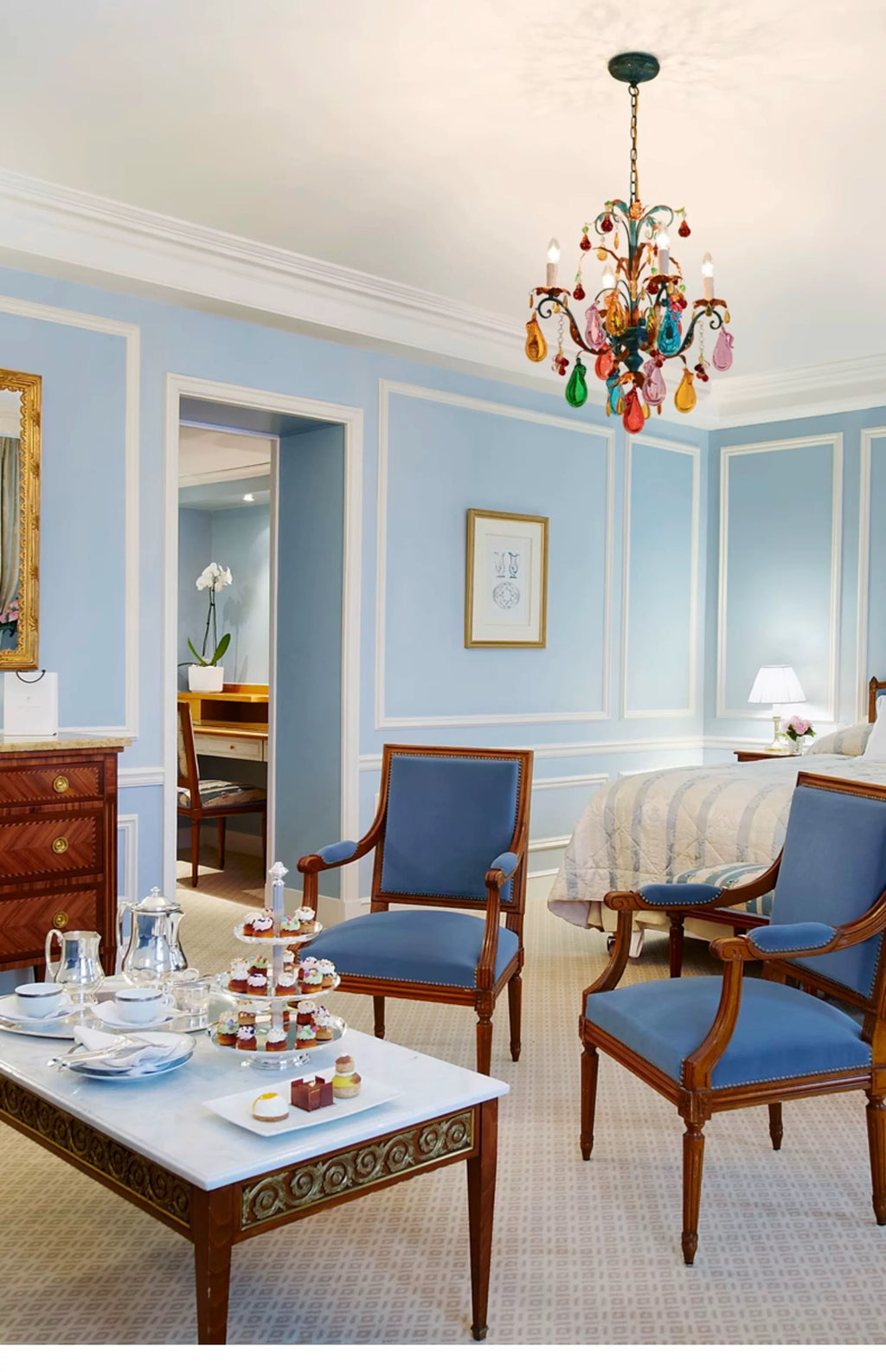 Multicolour four-light chandelier in a blue traditional bedroom.