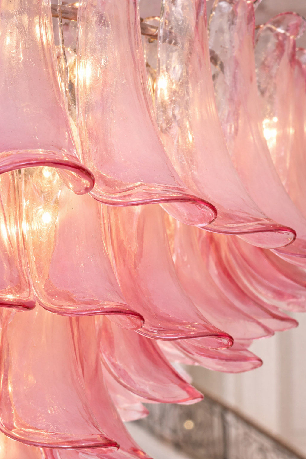 Close-up of overlapping textured translucent pink glass petals.