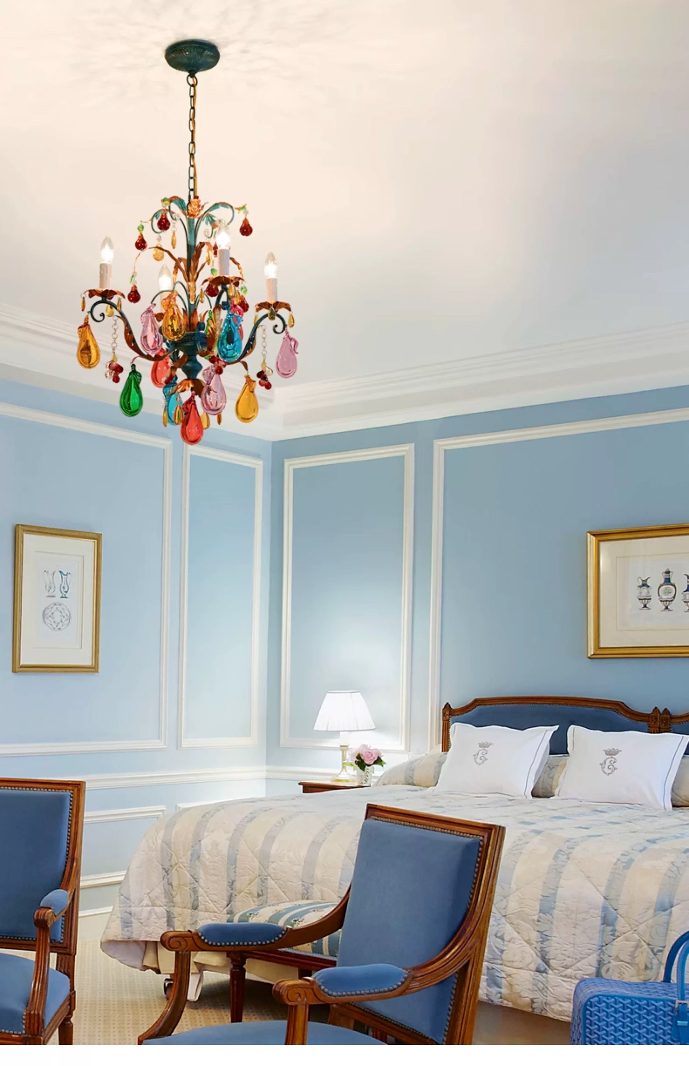 Four-light multicolour fruit chandelier in a blue bedroom.