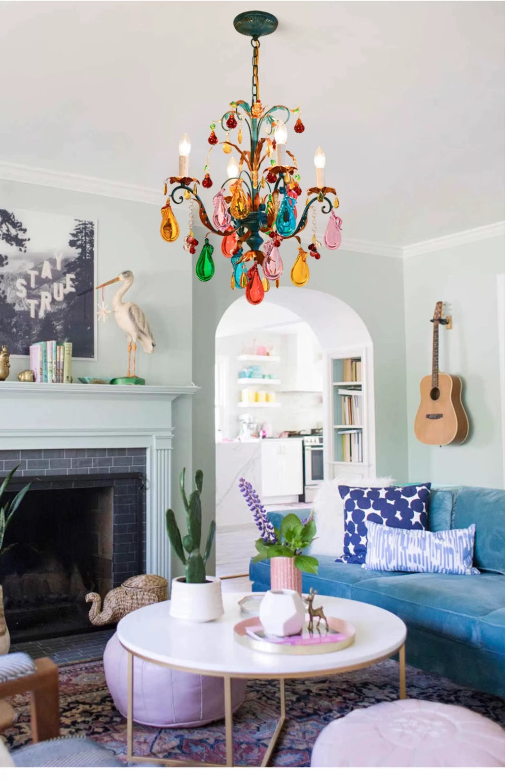 Multicolour teardrop glass chandelier with playful branching arms in an eclectic living room.