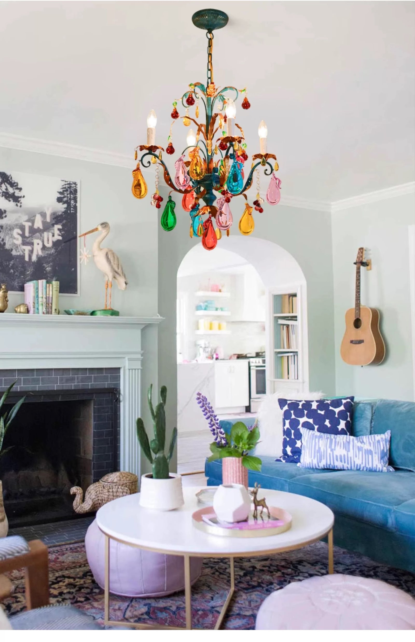 Multicolour teardrop glass chandelier with playful branching arms in an eclectic living room.