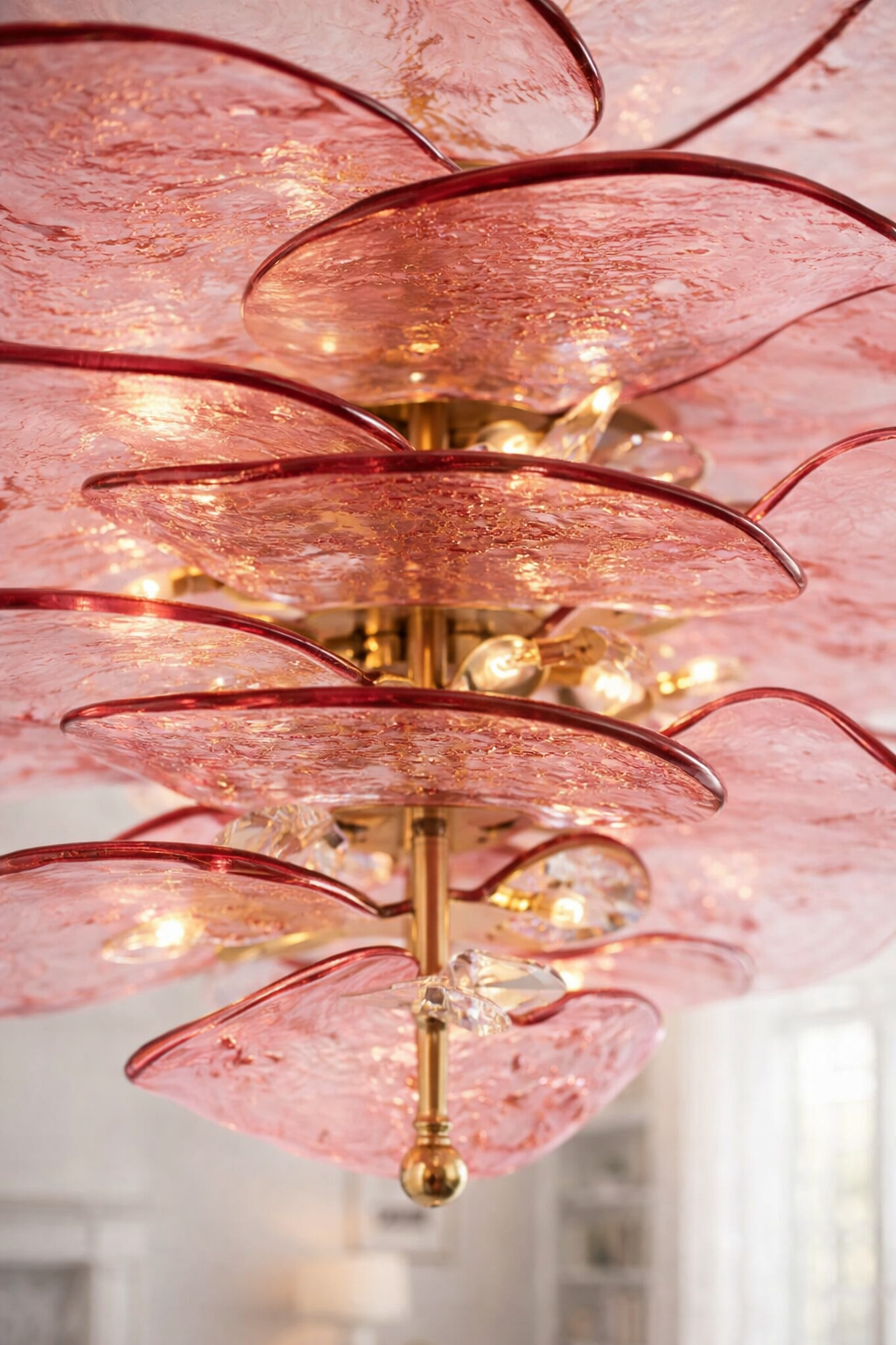 Close-up of overlapping textured blush-pink glass plates.