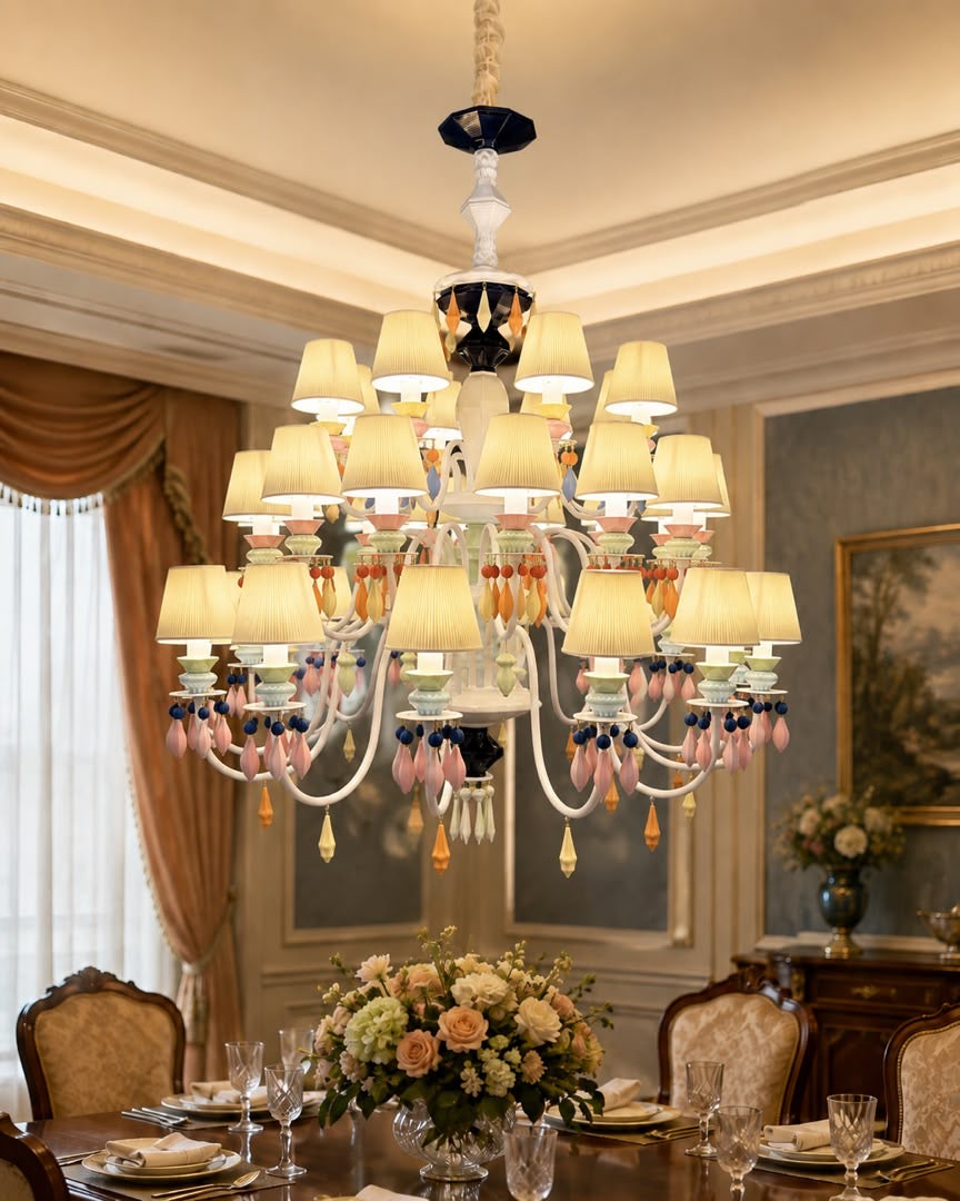 Belle Époque 36-light three-tier chandelier with ivory shades and pastel ornaments above a formal dining table.