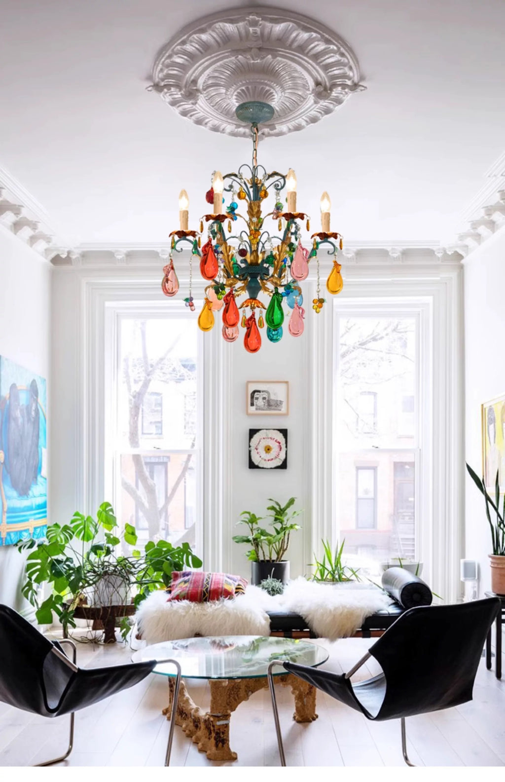 Multicolour glass-drop chandelier hanging in a high-ceiling living space.