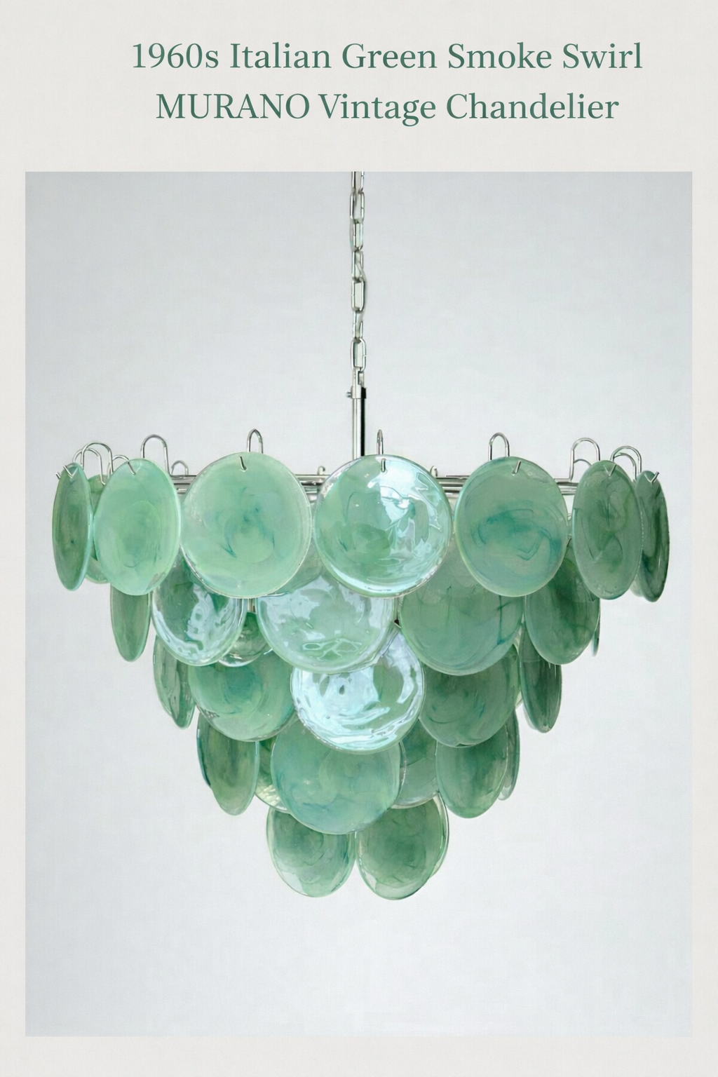 Emerald disc-glass cascade chandelier shown unlit against a neutral background.